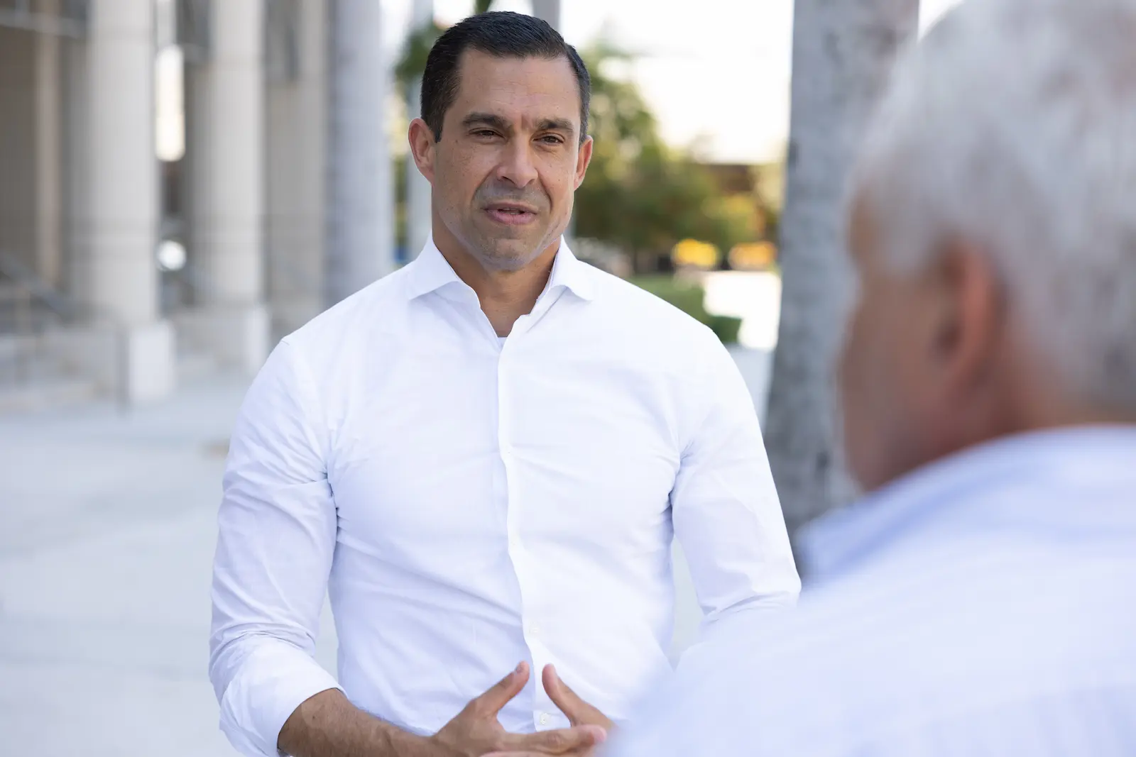 Mayor Vince Lago speaking with a resident